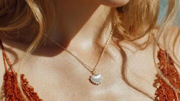 Woman wearing a delicate shell necklace during a sunny day at the beach photo