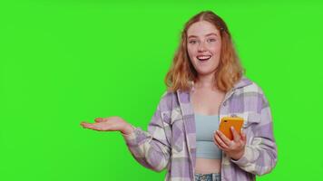Woman using smartphone showing pointing empty place, advertising application area, positive feedback video