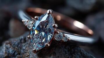 Elegant marquise cut diamond ring with rose gold accents resting on a textured gray surface photo