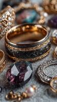 Elegant collection of ornate rings and gemstones displayed on a textured surface showcasing intricate details and craftsmanship photo