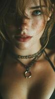 Portrait of a young woman with freckles wearing layered necklaces and soft lighting, highlighting her expressive features and natural beauty photo
