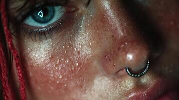 Close-up of a person with blue eyes and red hair showcasing facial features and piercings in soft light photo