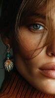 Close-up portrait of a woman wearing elegant earrings showcasing detailed features and vibrant eye color photo