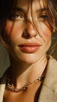 Close-up portrait of a woman with freckles and natural makeup, showcasing warm light and stylish fashion in a contemporary setting photo