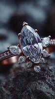 Sparkling diamond engagement ring set on a textured rock surface with soft natural light illuminating the gemstones photo
