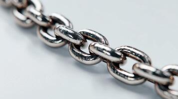 Close-up view of a silver metal chain highlighting the links and texture under natural lighting photo