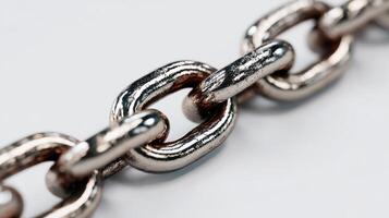 Close view of a metallic chain link displaying texture and shine, suitable for industrial or artistic applications photo