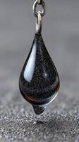 Captured essence of black obsidian pendant showcasing shimmering details against a blurred background photo