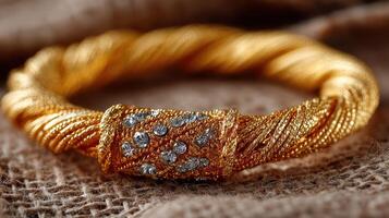 Elegant gold bracelet with sparkling gemstones showcased on textured fabric photo