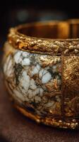 Intricate golden and marble bowl showcasing craftsmanship in a close-up view at an art exhibition photo