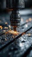 Laser cutting machine operating on metal surface creating sparks and droplets in a workshop environment photo