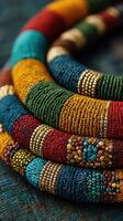 Colorful handcrafted beads in intricate patterns displayed on textured background photo