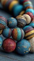 Colorful handcrafted wooden beads showcasing intricate textures and patterns in vibrant shades of blue, red, and gold photo