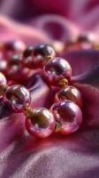 Elegant pearl necklace draped on luxurious pink fabric, showcasing timeless beauty and craftsmanship photo