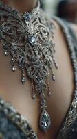 Detailed silver necklace adorned with intricate designs and gemstones showcases elegance at a formal gathering during evening photo