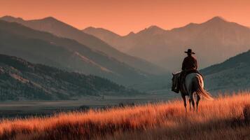Cowboy on horseback enjoys sunset over mountainous landscape in serene outdoor setting photo