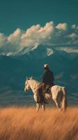 Riding through golden grasslands with mountains in the distance during a serene afternoon in nature photo