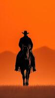 Silhouette of a cowboy on horseback against a stunning sunset in the open plains photo