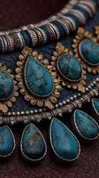 Intricate jewelry design featuring turquoise stones and ornate metalwork displayed on a dark surface photo