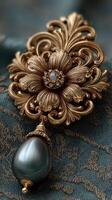 Exquisite vintage brooch featuring intricate floral design and pearl drop on elegant fabric background photo