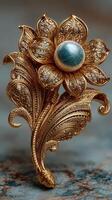 Intricate gold floral brooch featuring a large stone in the center and detailed leaf design photo