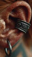 Close-up of ornate silver ear jewelry highlighting intricate design and texture during a creative arts event photo