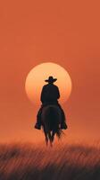 Cowboy rides into the sunset in a wide open field at dusk, silhouette against an orange sky photo