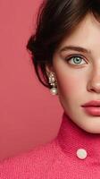 Close-up of a model with striking blue eyes wearing a pink sweater and elegant earrings against a vibrant pink background photo
