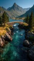 Serene mountain landscape with a stone bridge and clear river during daytime in a picturesque valley photo