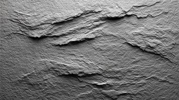 Detailed abstract texture of layered gray rock surface captured under soft lighting in a studio setting photo