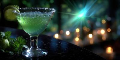 Refreshing green cocktail sits on a dark counter as candles glow in the background during an evening gathering photo