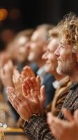 Audience members applauding at a live performance during a cultural event in the evening photo