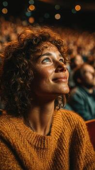 Audience member enjoying a performance with bright expressions in a packed theater during a late evening show photo