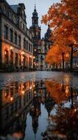 Historic architecture reflects in autumn puddle at twilight in a quiet town square photo
