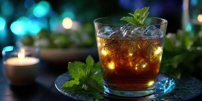 Relaxing evening with a refreshing mocktail served in an elegant glass with ice and mint garnish near candles photo