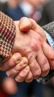 Hands shake during a formal greeting at a business event in the city center on a sunny afternoon photo