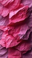 Colorful layers of crinkled paper in varying shades of pink creating a textured abstract background photo