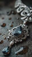 Elegant silver jewelry with blue gemstones displayed on a textured surface in soft lighting photo