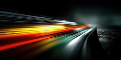 Dynamic light trails create a vibrant display on a dark road surface during nighttime photo