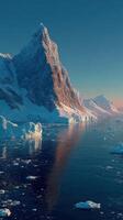Majestic mountain peak reflecting in calm waters of an icy fjord at sunrise in the Antarctic landscape photo