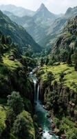 Scenic mountain landscape with a waterfall cascading into a lush valley during daylight photo