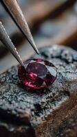 Beautiful ruby gemstone being carefully examined with precision tools in a workshop setting during daylight hours photo