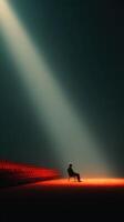 Lonely figure sitting on a chair illuminated by a beam of light in an empty theater during a quiet evening photo