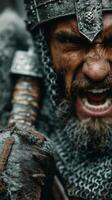 Fierce warrior in chainmail ready for battle with spear in hand during a medieval reenactment in a forest setting photo