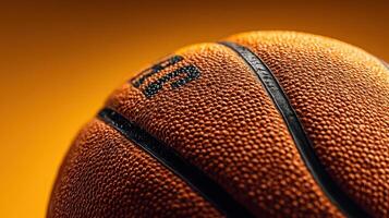 Close-up shot of a basketball against a vibrant orange background highlighting texture and detail in an indoor setting photo