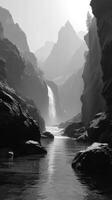Stunning waterfall cascades through rocky canyon with towering peaks in the background during a misty morning photo