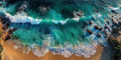Vibrant ocean waves crash onto a sandy shore at sunset overlooking rocky coastline views photo