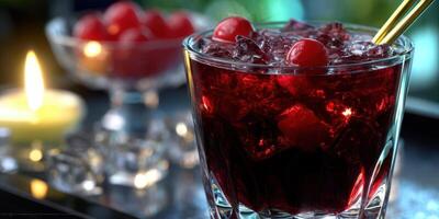 Refreshing cherry cocktail served with ice in a stylish glass during a cozy gathering at night photo