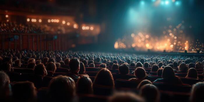 Crowd enjoying a live performance in a vibrant theater setting during the evening hours photo