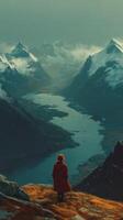 Stunning mountain landscape with a solitary figure gazing at a winding river during twilight in a serene location photo